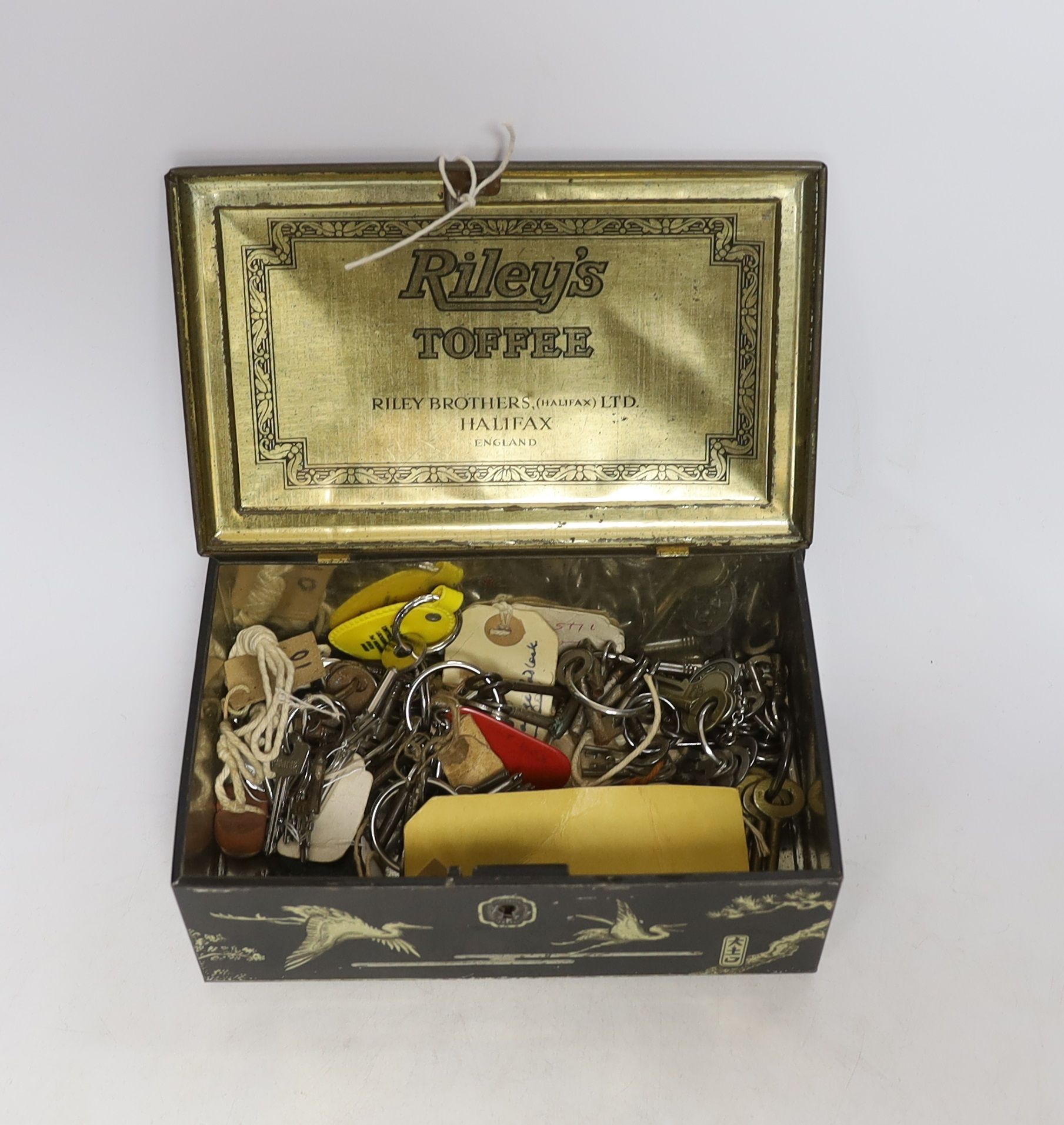 A collection of Victorian and later furniture and lock keys housed in a vintage tin